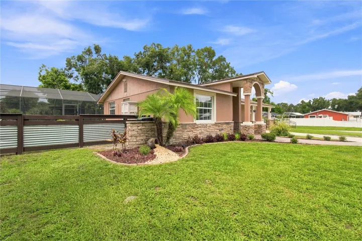 Front View warm color stone decor blends for a cohesive upgrade look, with Portico and Porch, paved walkway to complete the beautiful curb appeal.
