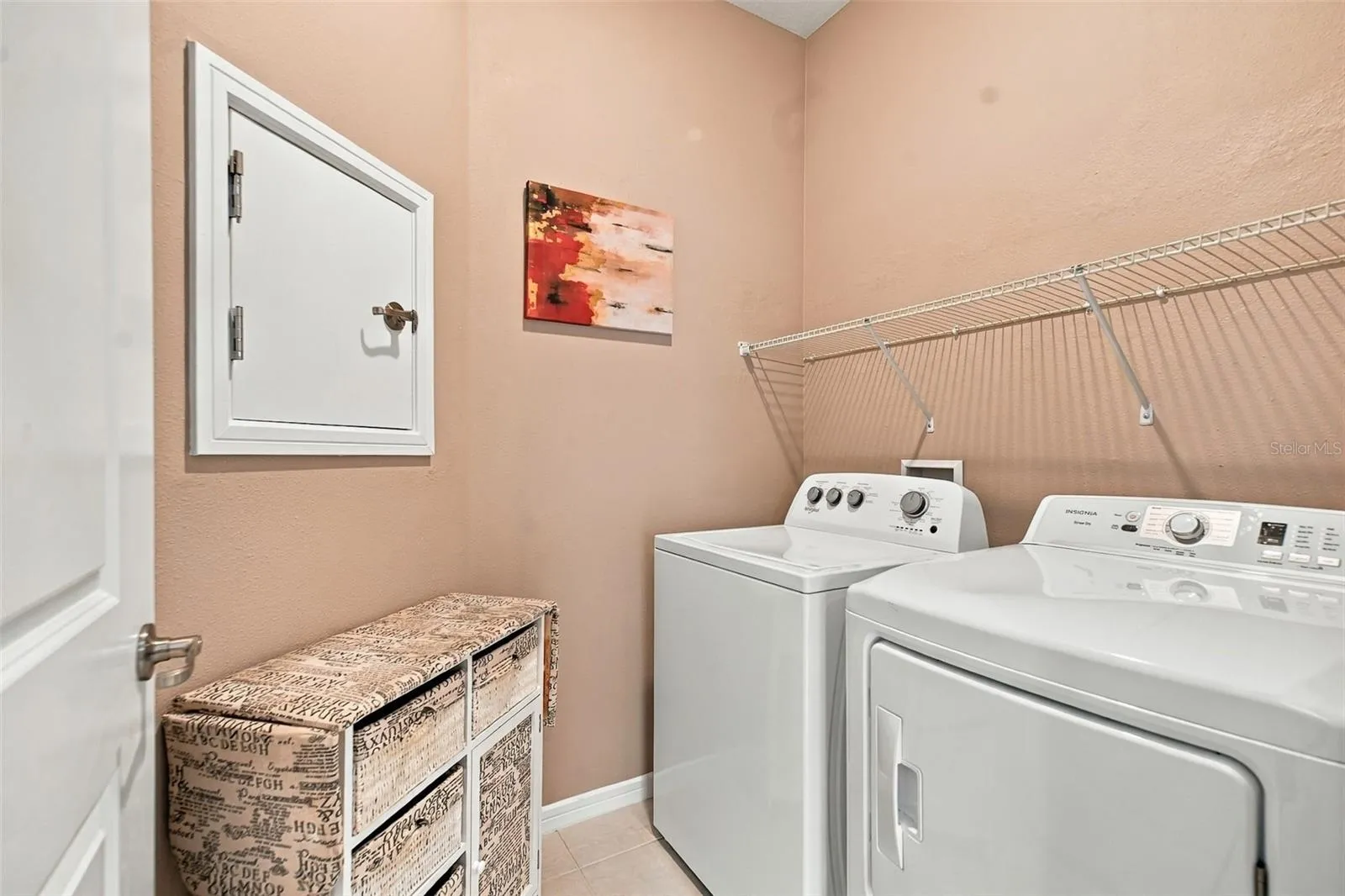 Indoor Laundry Room w/washer &amp; dryer set, built-in shelf, &amp; laundry chute door to Primary Closet