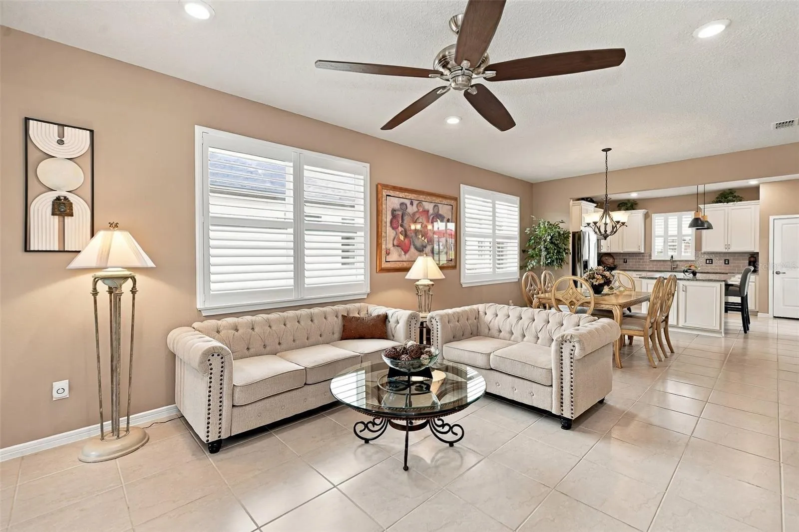 Living Rm area with ceiling fan &amp; double window w/plantation shutters