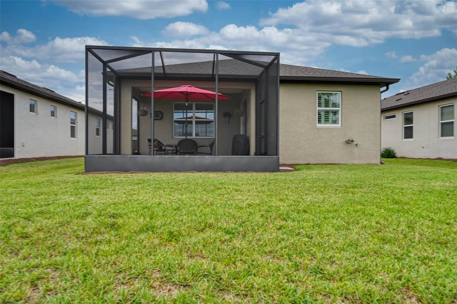 Rear view of home &amp; screened lanai w/cage