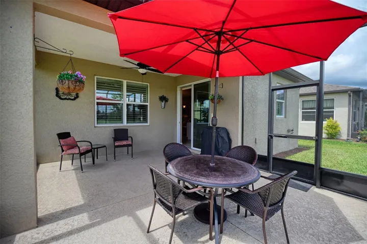 Covered screened lanai w/additional screen cage, accessible via sliding glass doors from Kitchen