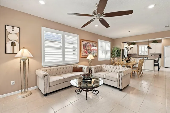 Living Rm area with ceiling fan &amp; double window w/plantation shutters
