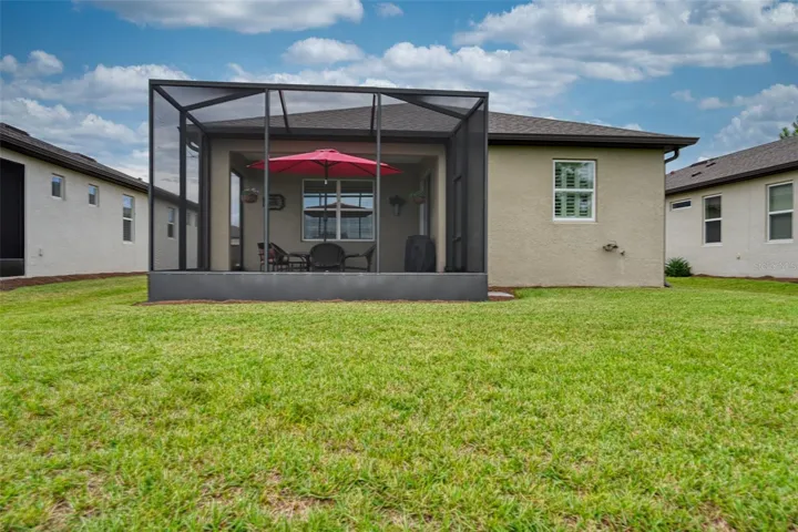 Rear view of home &amp; screened lanai w/cage
