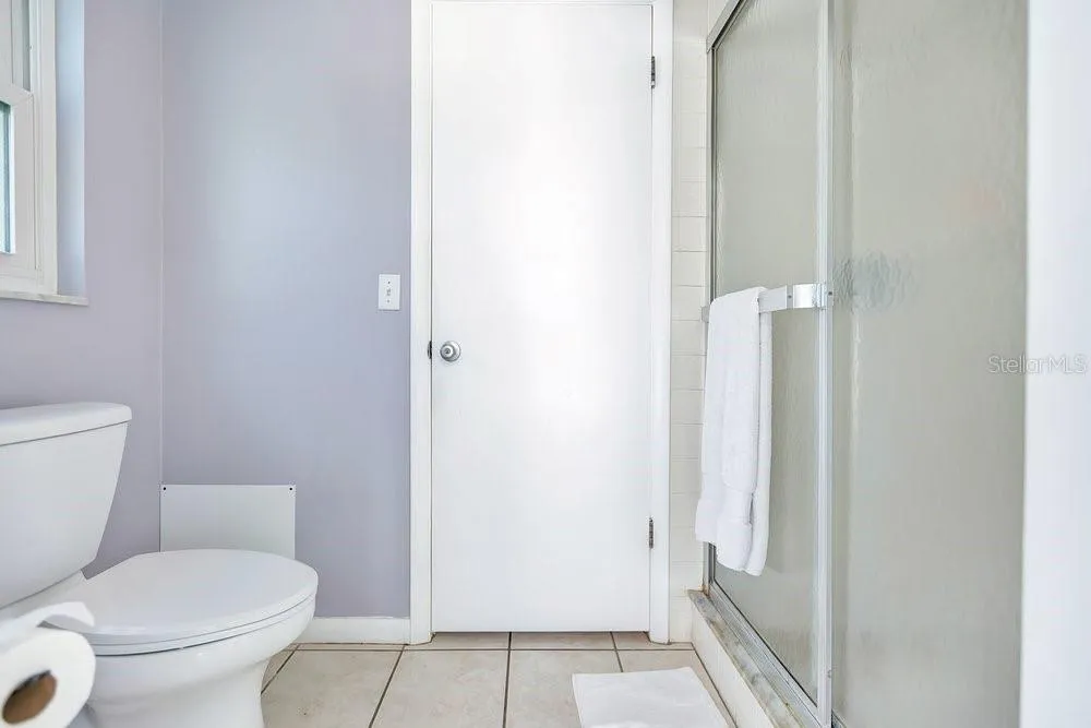 Primary water closet has pool access with shower and door that can be shut from the bedroom