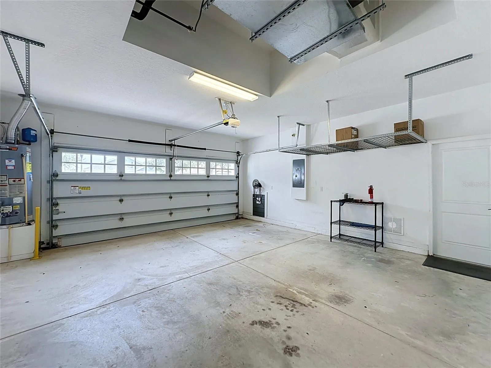2 CAR GARAGE OFFERS OVERHEAD STORAGE RACKS