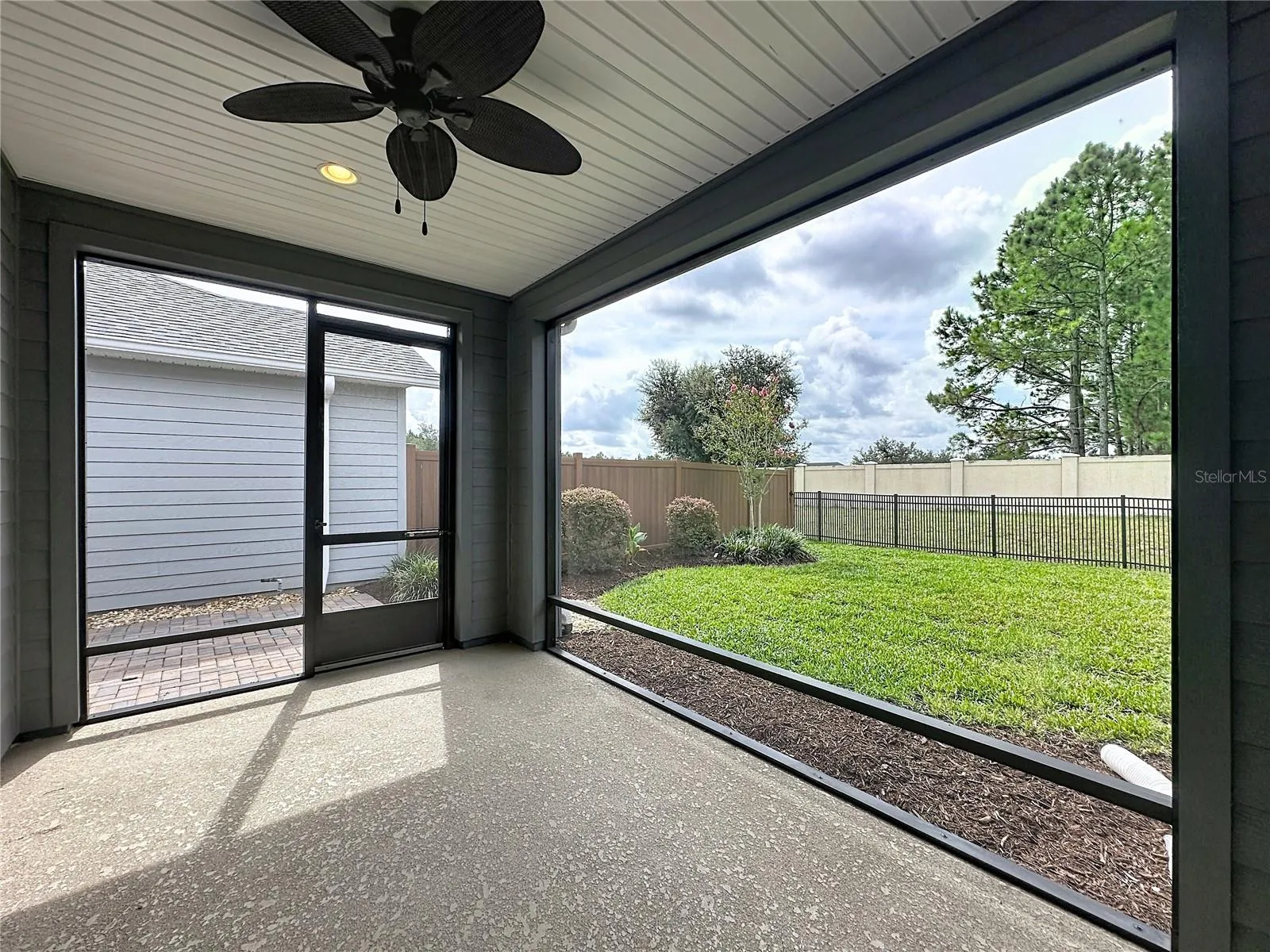 SCREENED IN BACK PORCH WITH VIEW OF WOODED BACKDROP