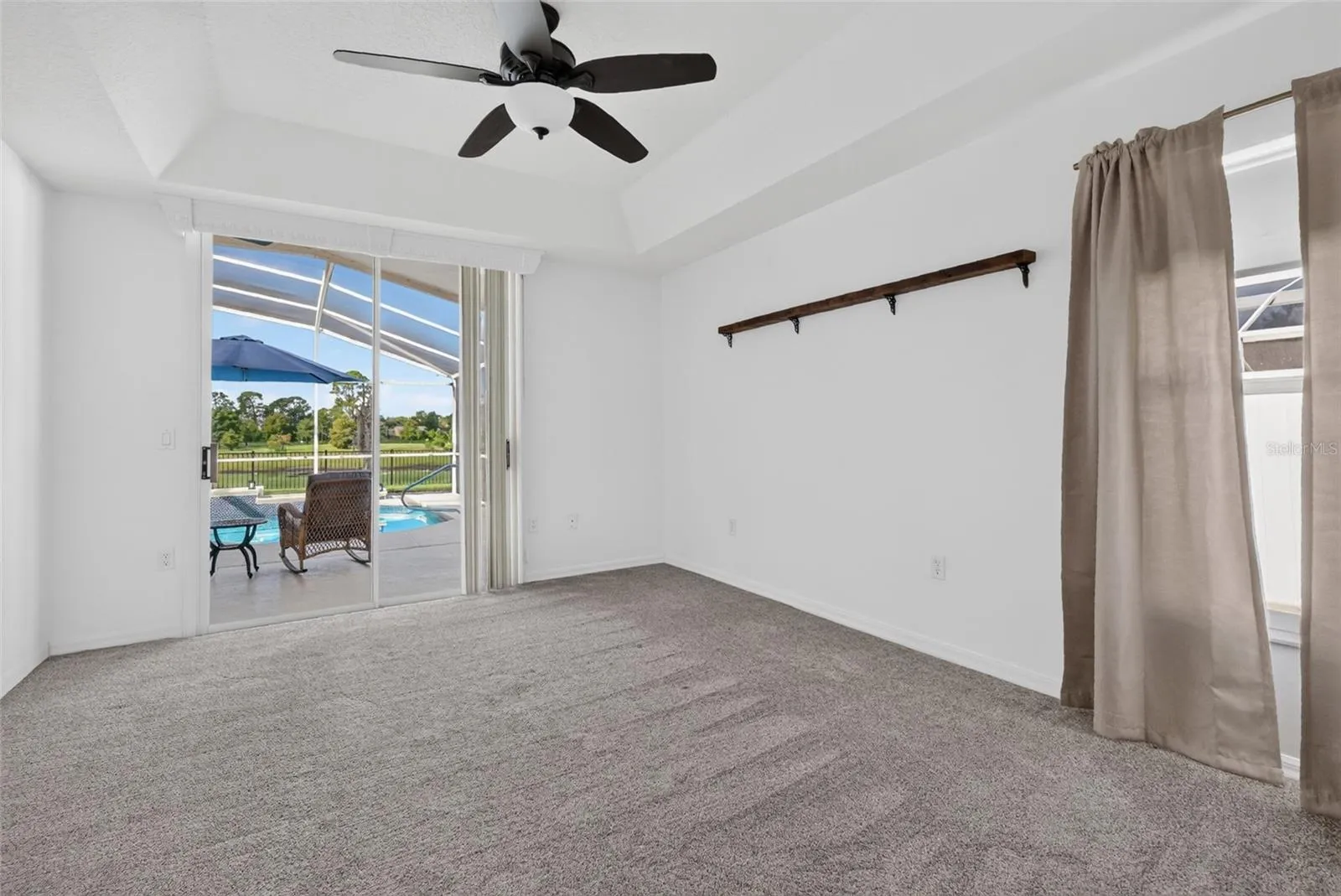 Primary Bedroom with a view of the lake and pool