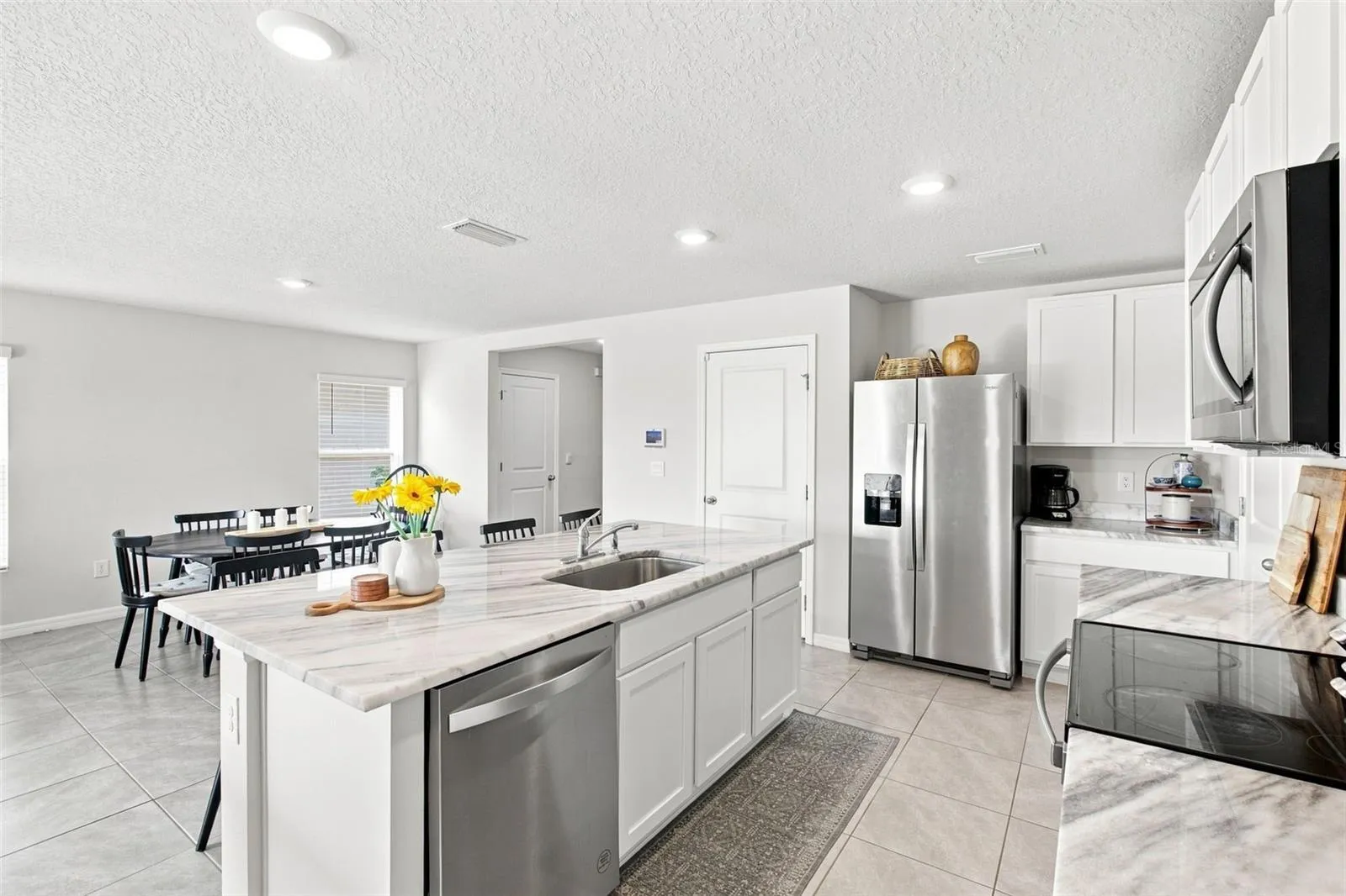 Bright kitchen, replete with cabinetry and storage