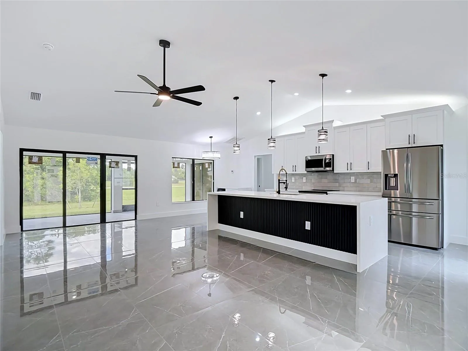 Another view of the open floor plan including the living room, kitchen & dining areas
