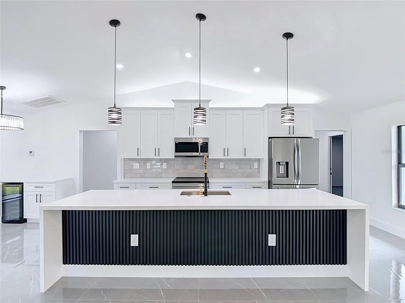 View of extraordinary gourmet kitchen with 10 foot Waterfall Island