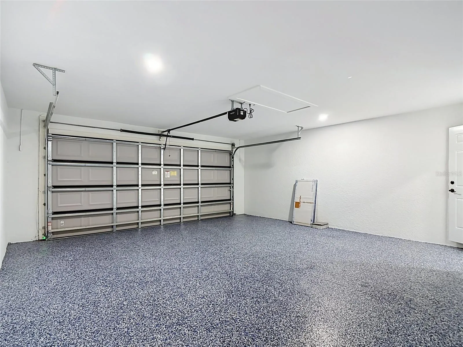 Another view of garage including the attic storage area
