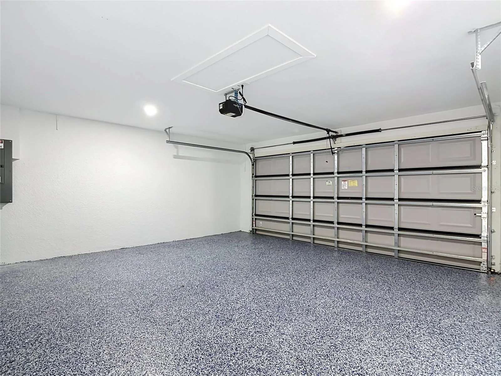 View of garage with finished flooring