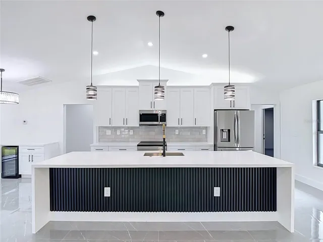 View of extraordinary gourmet kitchen with 10 foot Waterfall Island