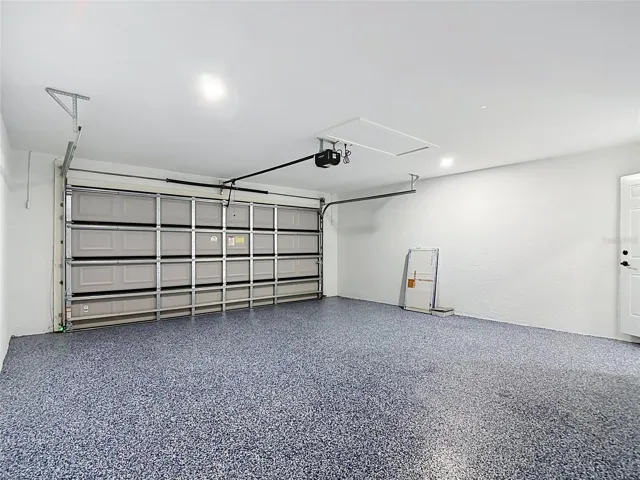 Another view of garage including the attic storage area