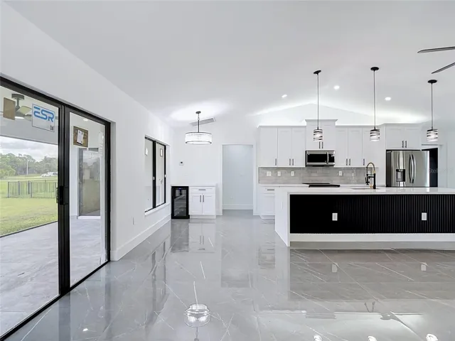 Another view of the dining area & kitchen