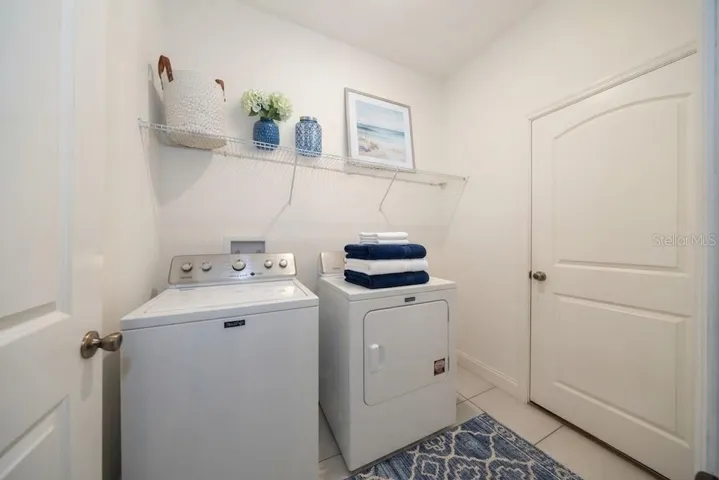 LAUNDRY ROOM, WITH DOOR TO GARAGE. WASHER AND DRYER CONVEY