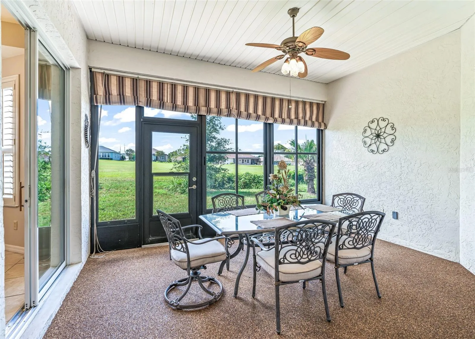 Enclosed Lanai w/Chattahoochee river rock flooring and access to the backyard