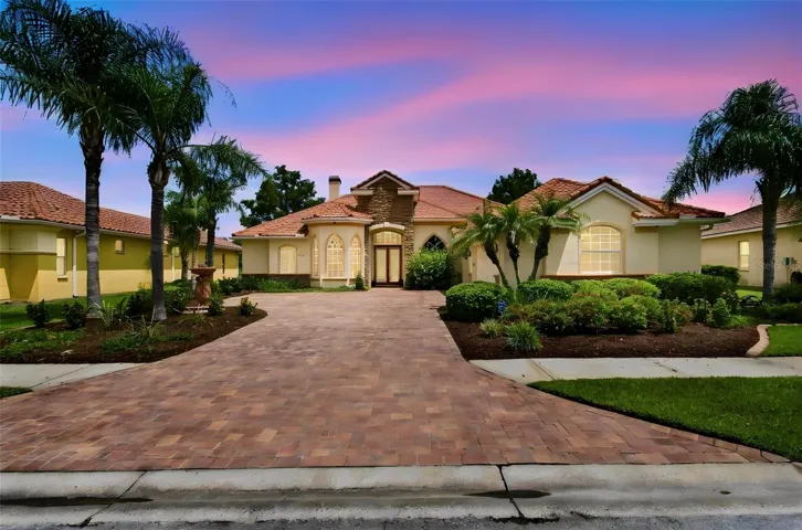 Beautiful pavered driveway with 3-car side load garage