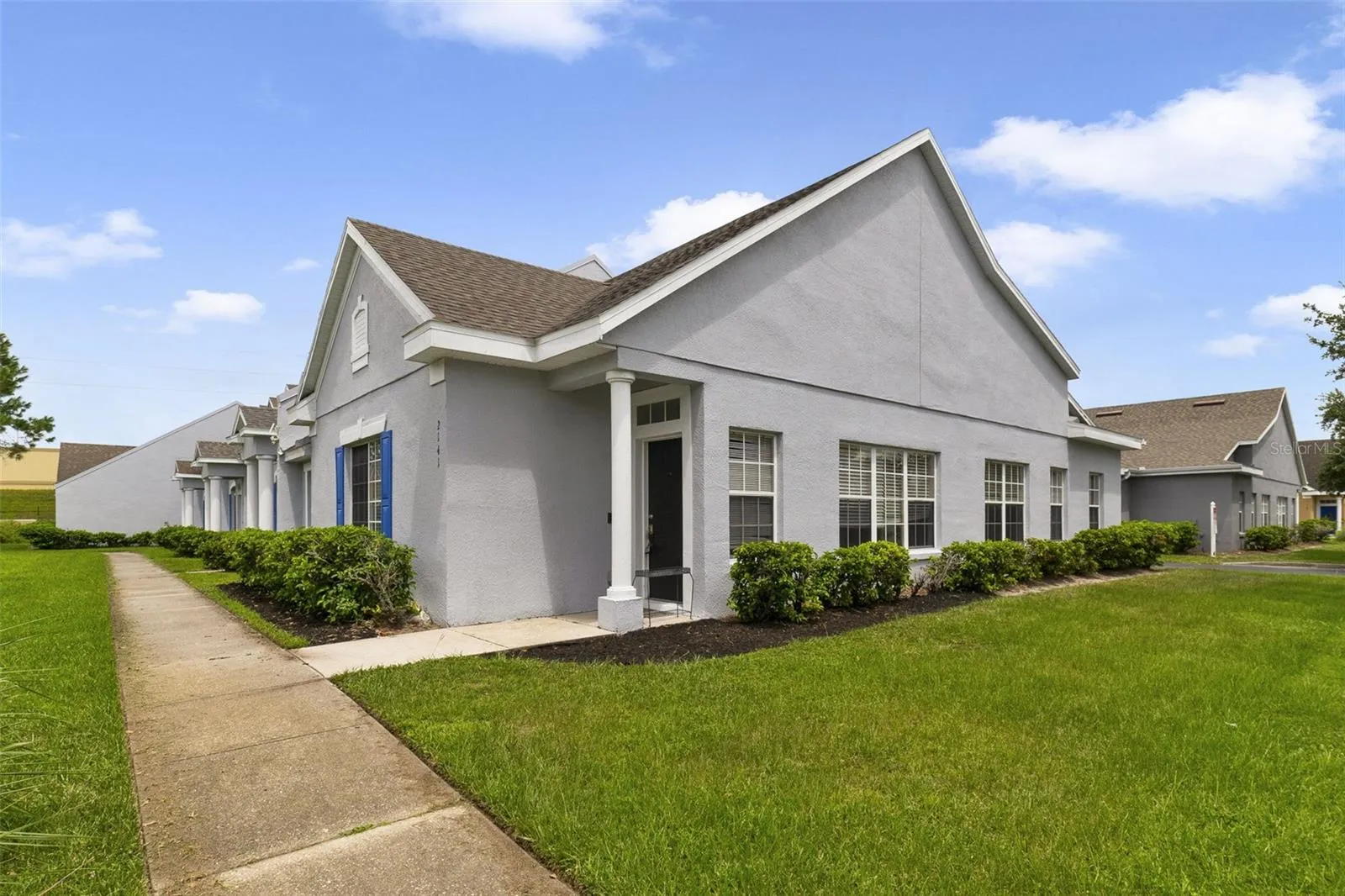 The home is positioned on a CORNER LOT with meticulously maintained landscaping, lush green lawn and a 2-CAR REAR-ENTRY GARAGE.