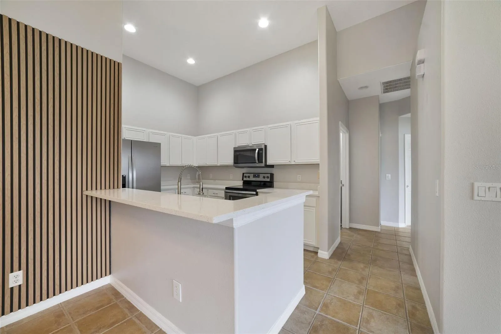 With room for counter-height stools, the breakfast bar doubles as a comfortable spot for quick meals or gathering with guests.