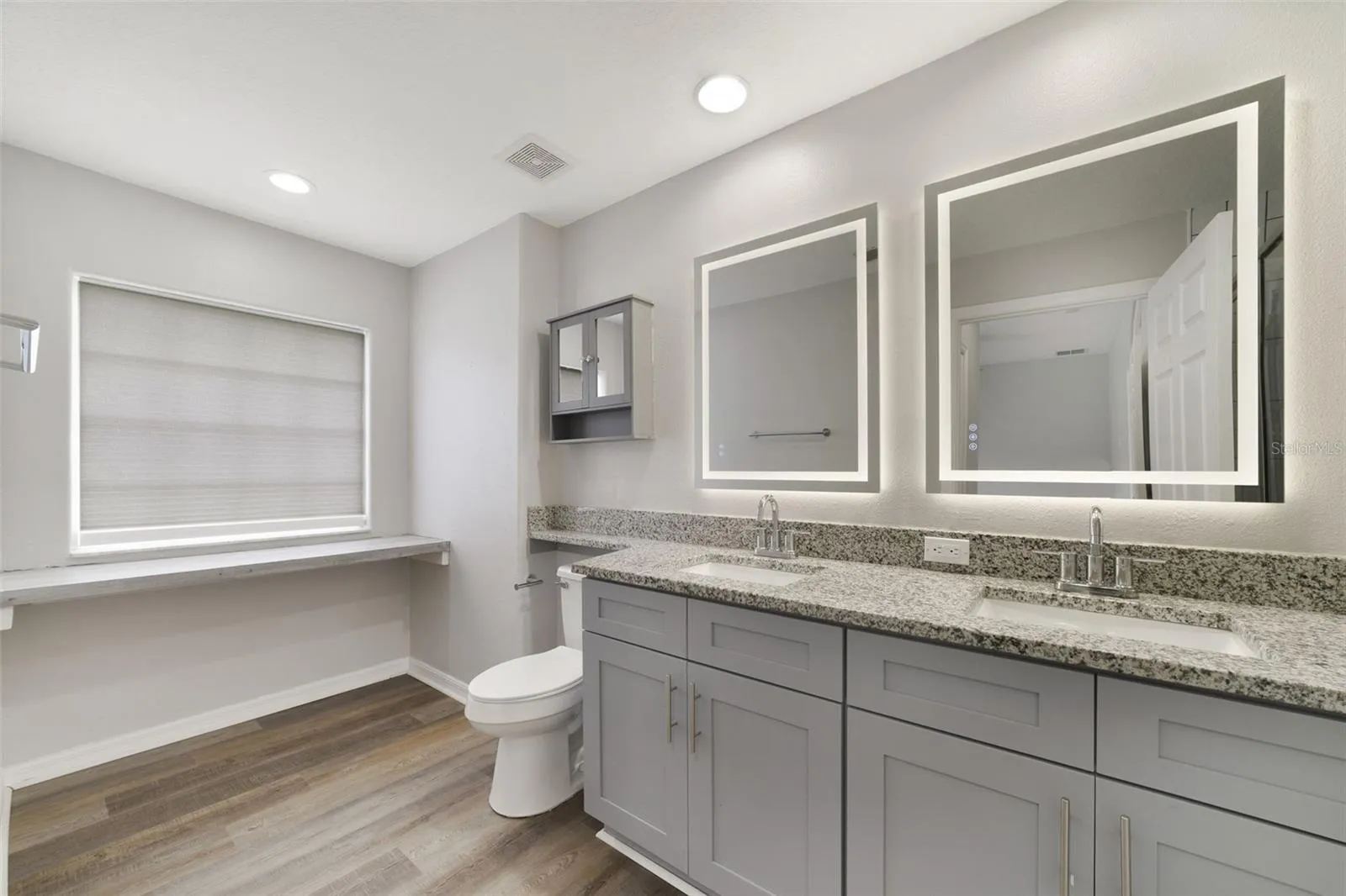 The private en-suite bath is complete with DUAL SINKS and a STEP-IN SHOWER.