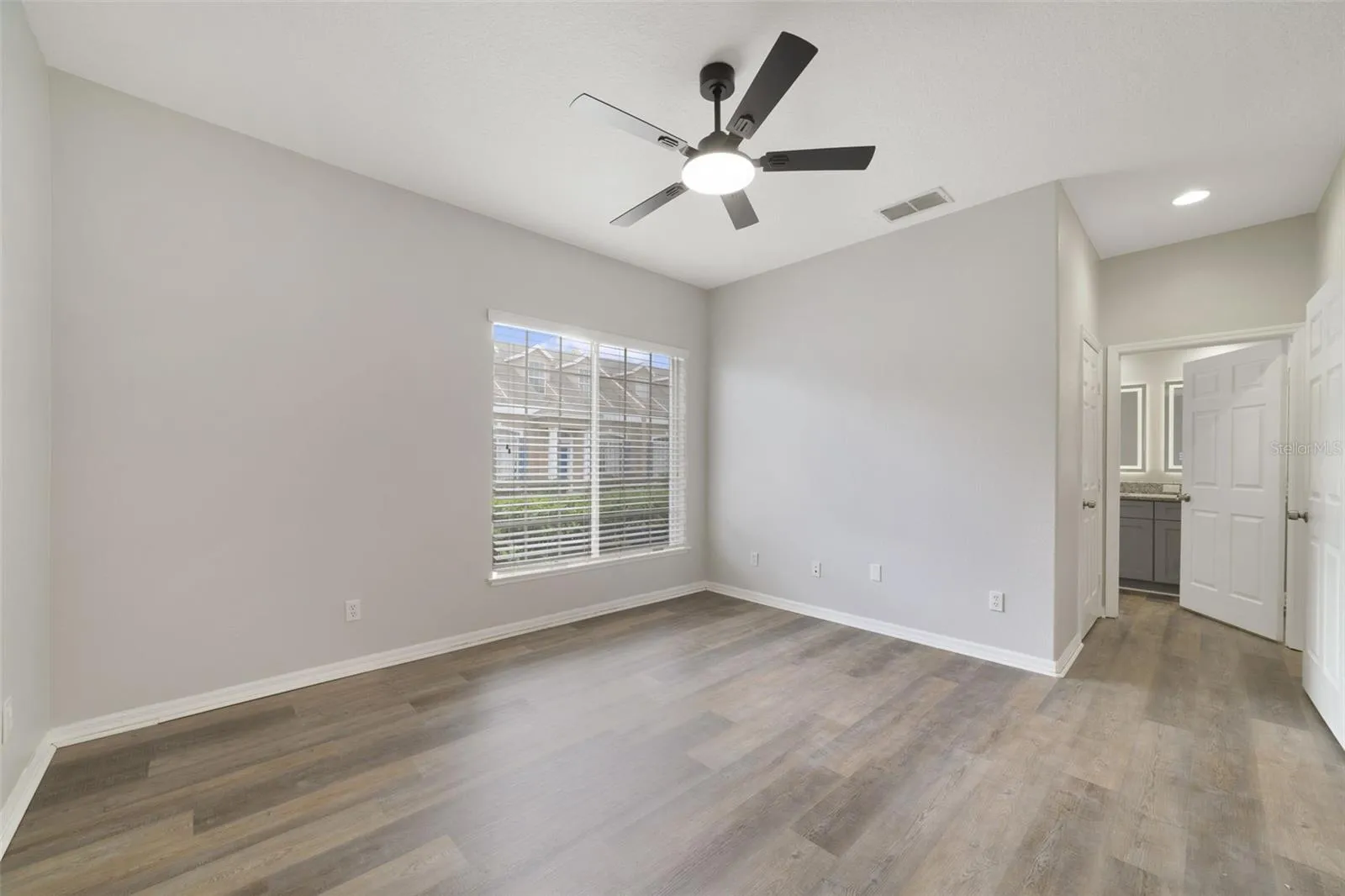 The spacious PRIMARY BEDROOM offers a WALK-IN CLOSET and private en-suite bath with DUAL SINKS and STEP-IN SHOWER.