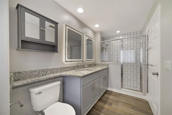 The private en-suite bath is complete with DUAL SINKS and a STEP-IN SHOWER.