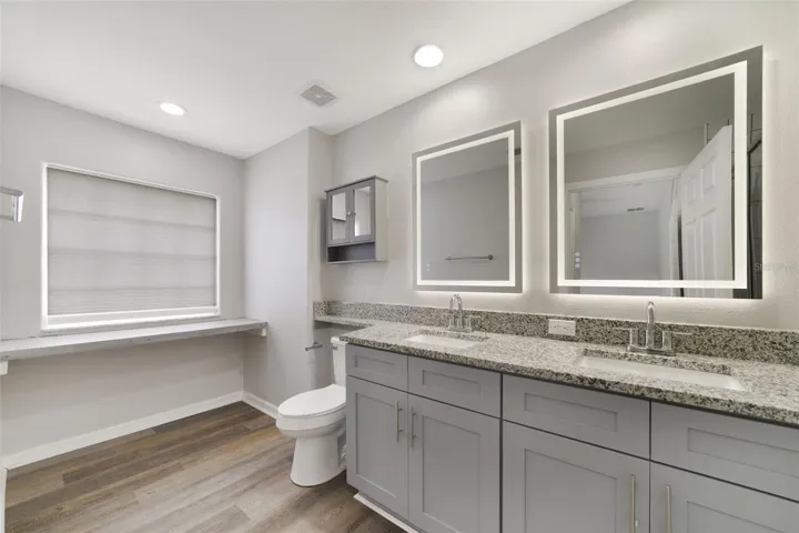 The private en-suite bath is complete with DUAL SINKS and a STEP-IN SHOWER.