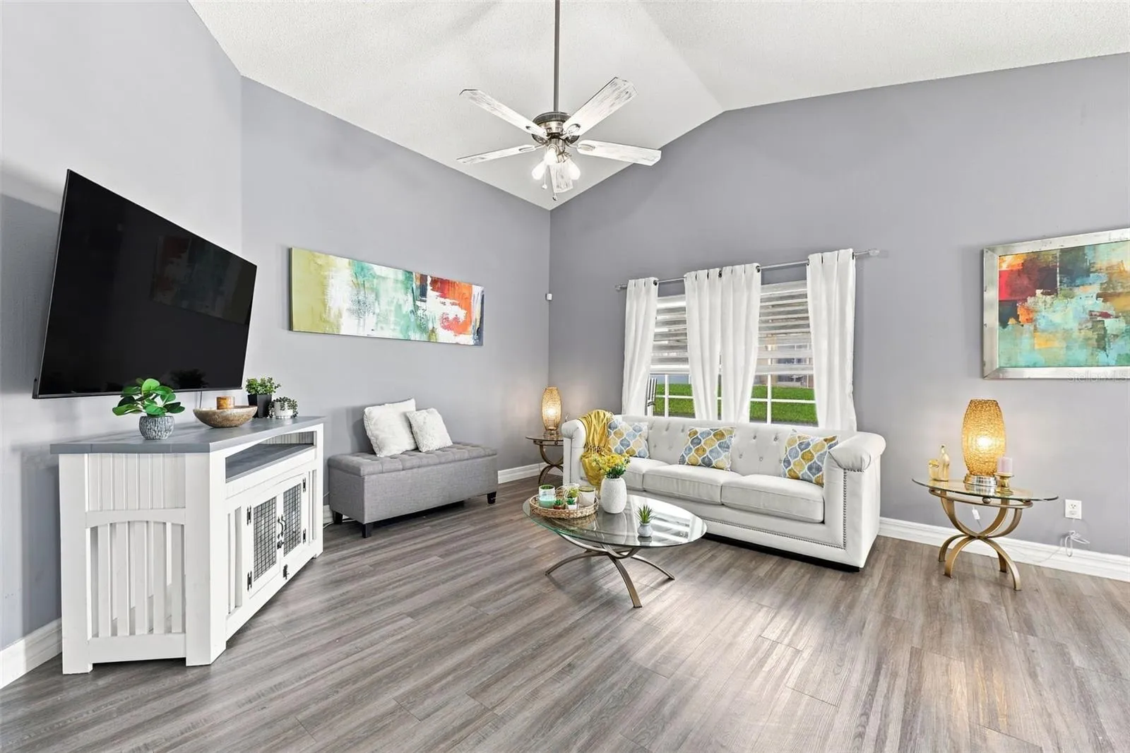 The open and inviting living room offers plenty of space to relax, gather, and entertain while flowing seamlessly into the surrounding living areas.