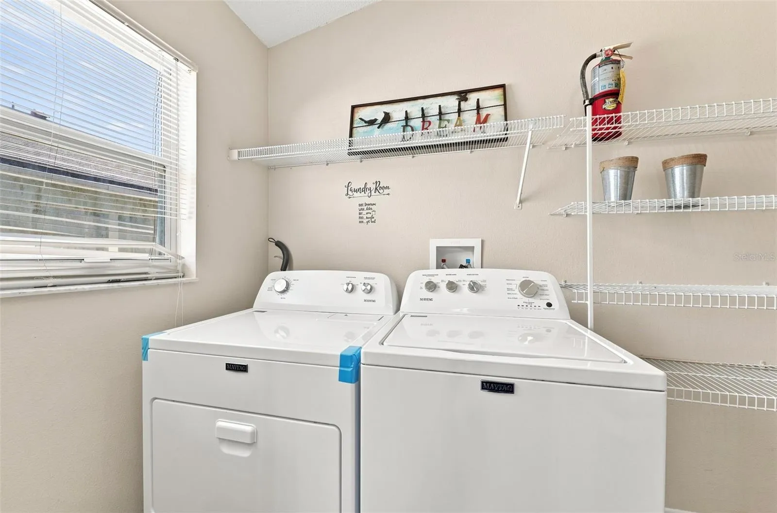 The laundry area offers added convenience alongside a **large walk-in pantry**, providing plenty of storage to keep everything organized and within easy reach.