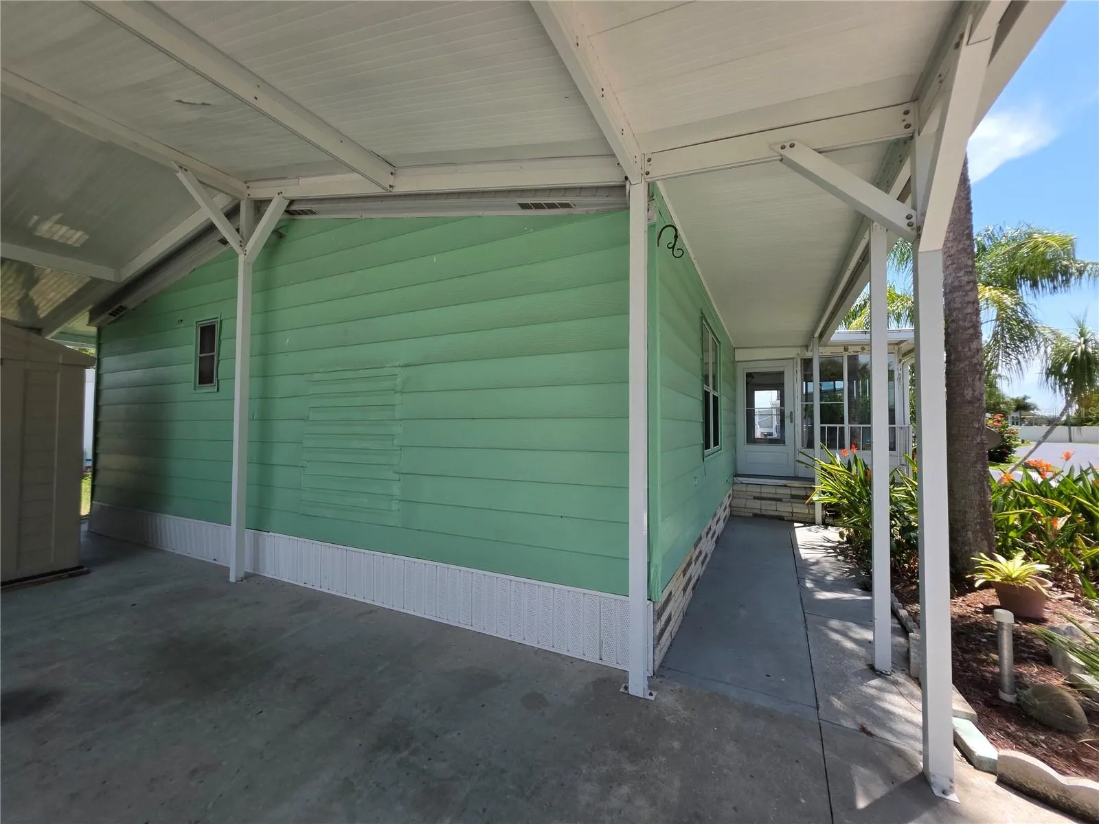 Newer carport with shed