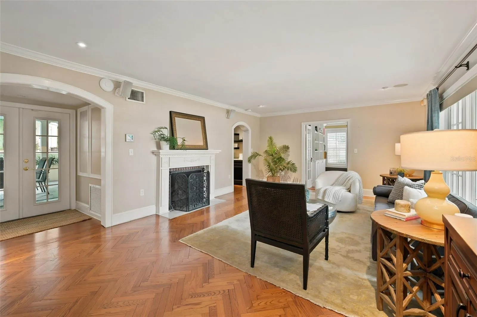 Formal Living Room with Wood Burning Fireplace, Privately Located Bathroom and French Doors to Covered Lanai.