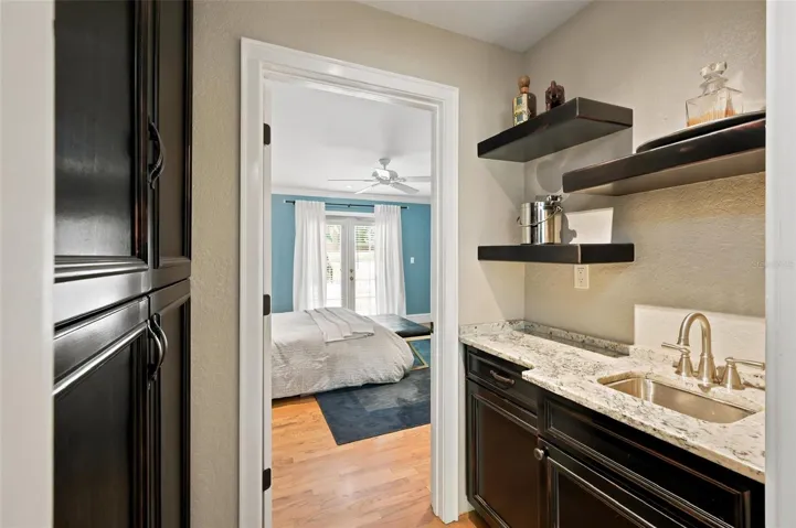 Convenient Storage and Wet Bar or Coffee Bar Well Located Between the Formal Living Room and Alternate Primary Bedroom