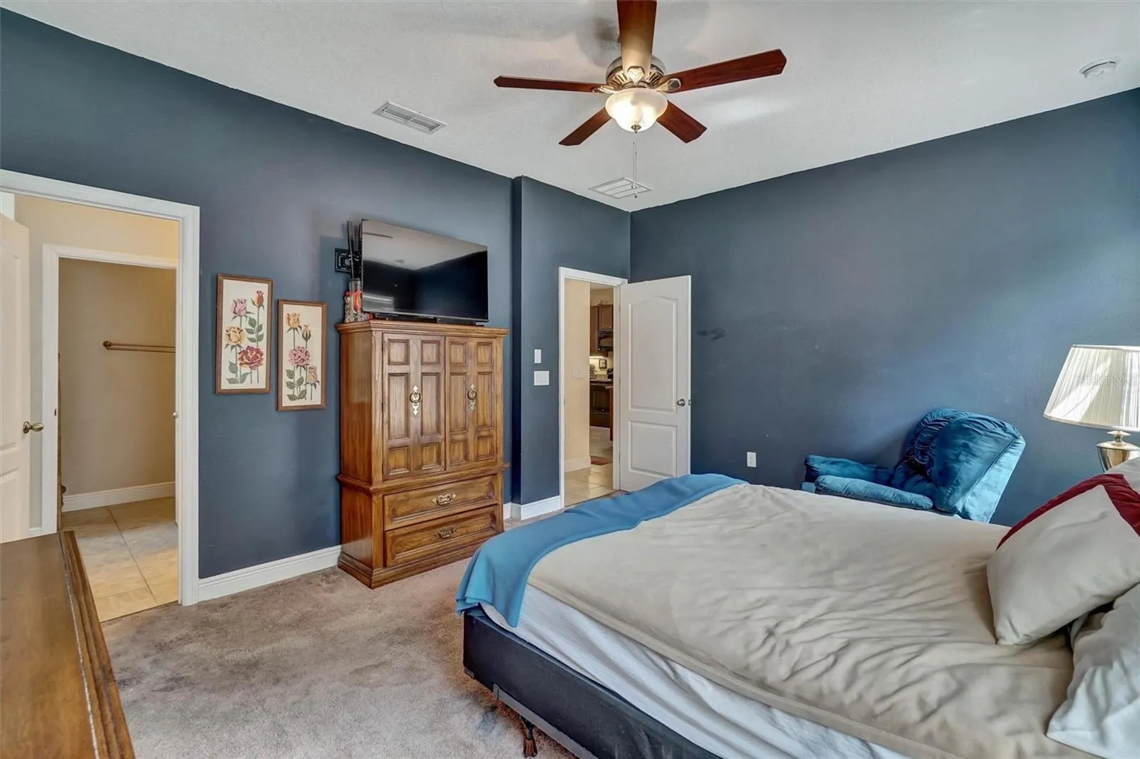 Bedroom ViewComfortable primary bedroom featuring a ceiling fan and ample storage.