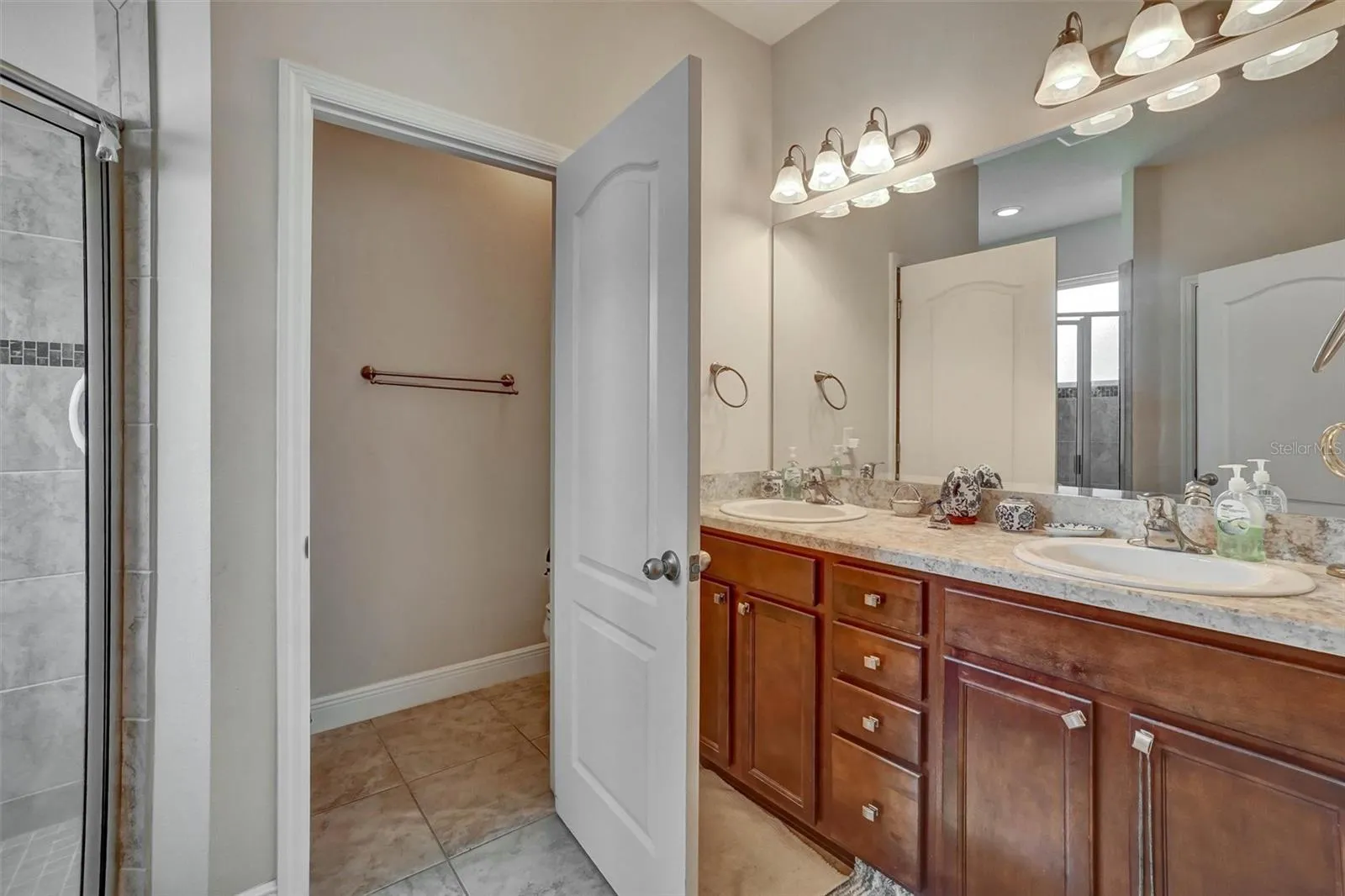 Primary Bathoom Dual vanity countertops and a large walk in shower