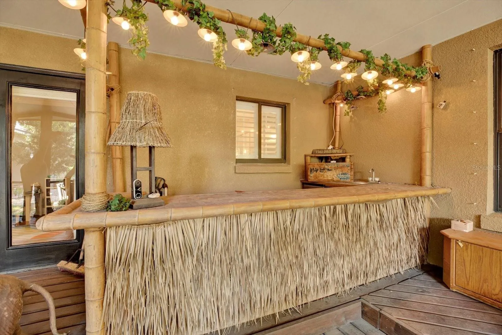 Custom tiki bar anchors the outdoor entertaining space.