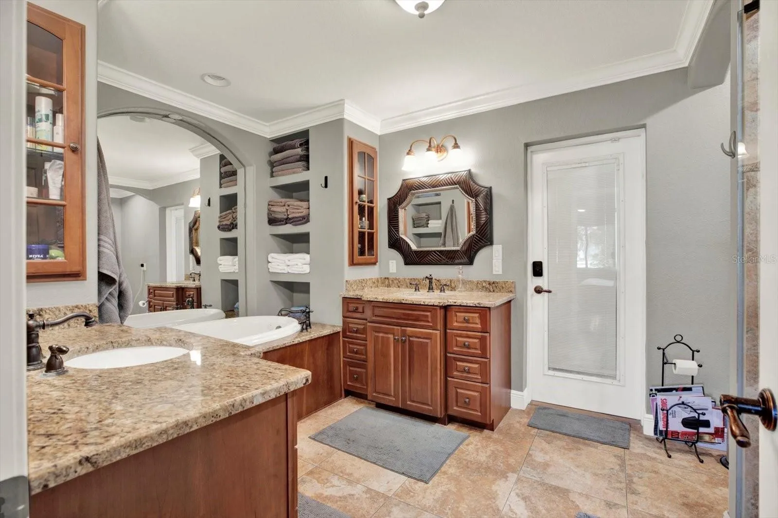 Primary bath includes a walk-in shower and built-in linen shelving.