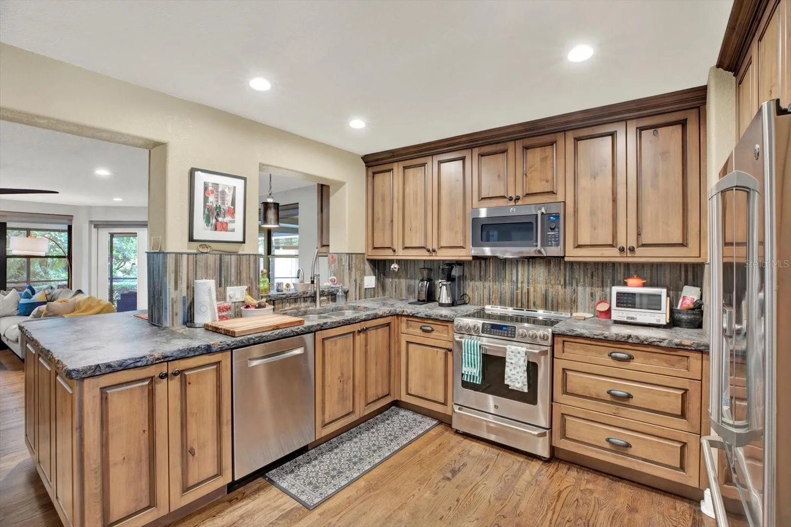 Custom cabinetry and stainless appliances throughout the chef's kitchen.