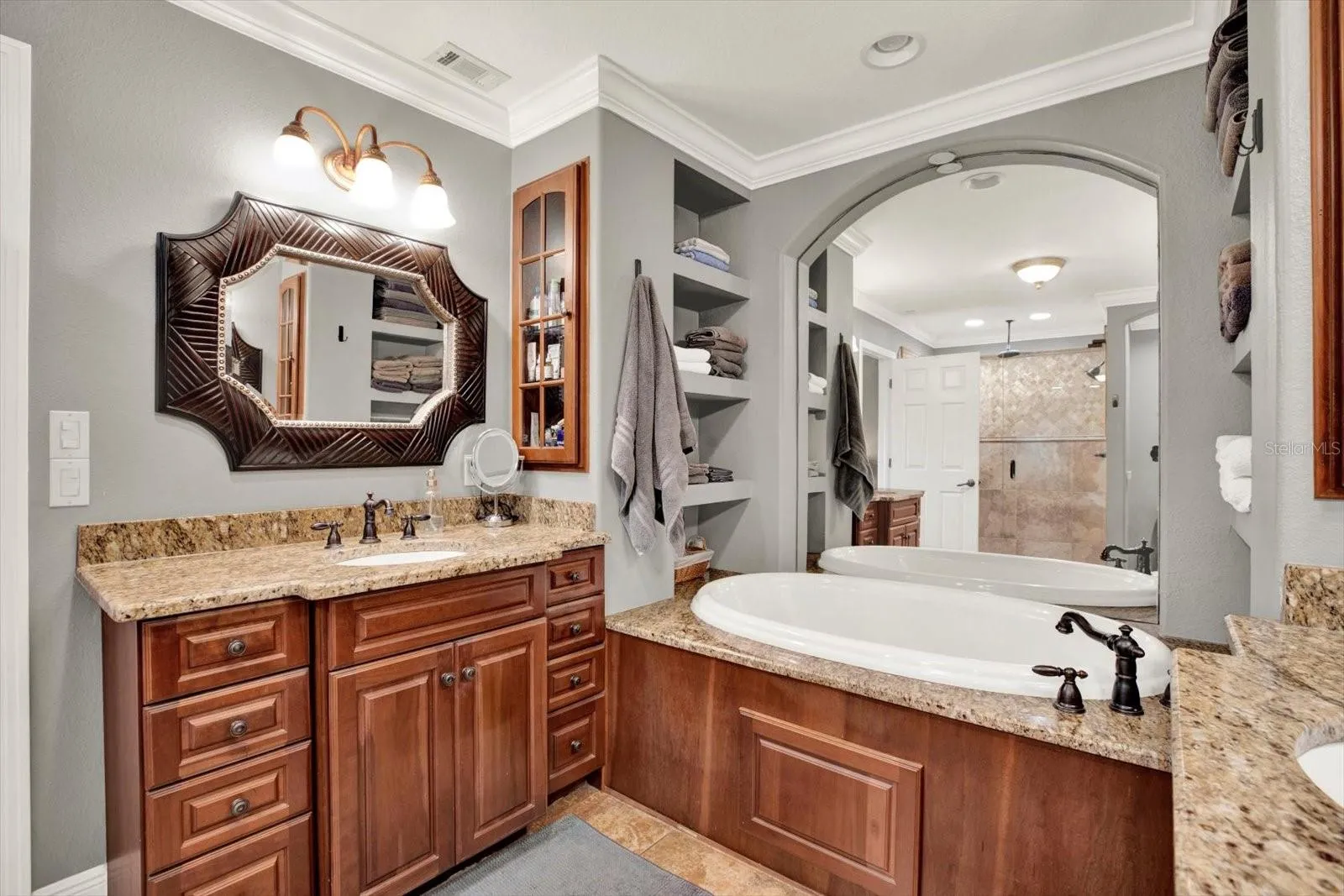 Primary bath features a dual vanity and a garden soaking tub.