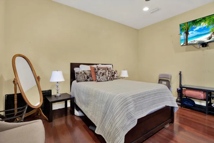 Casita / guest house bedroom with wood floors.