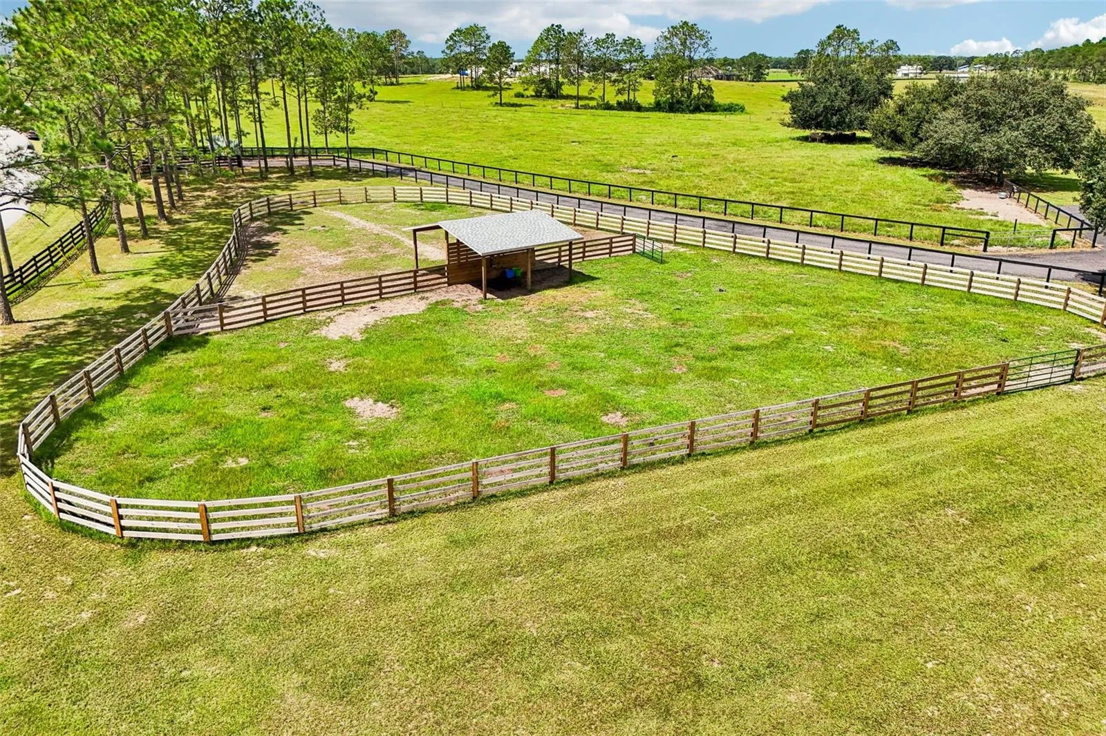 A shared 20' x 24' run-in barn between Paddocks 1 & 2 provides a spacious, shaded shelter for the horses.