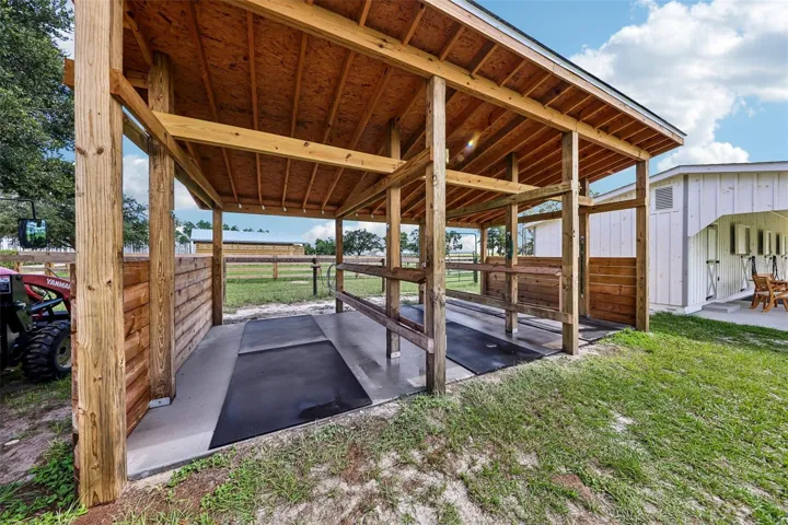 Heavy-duty overhead beams provide secure tie points for safely handling horses, including dental visits and routine care.