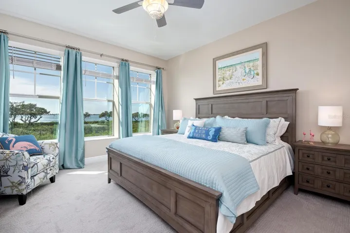 large primary suite with lots of windows and natural light and bay views