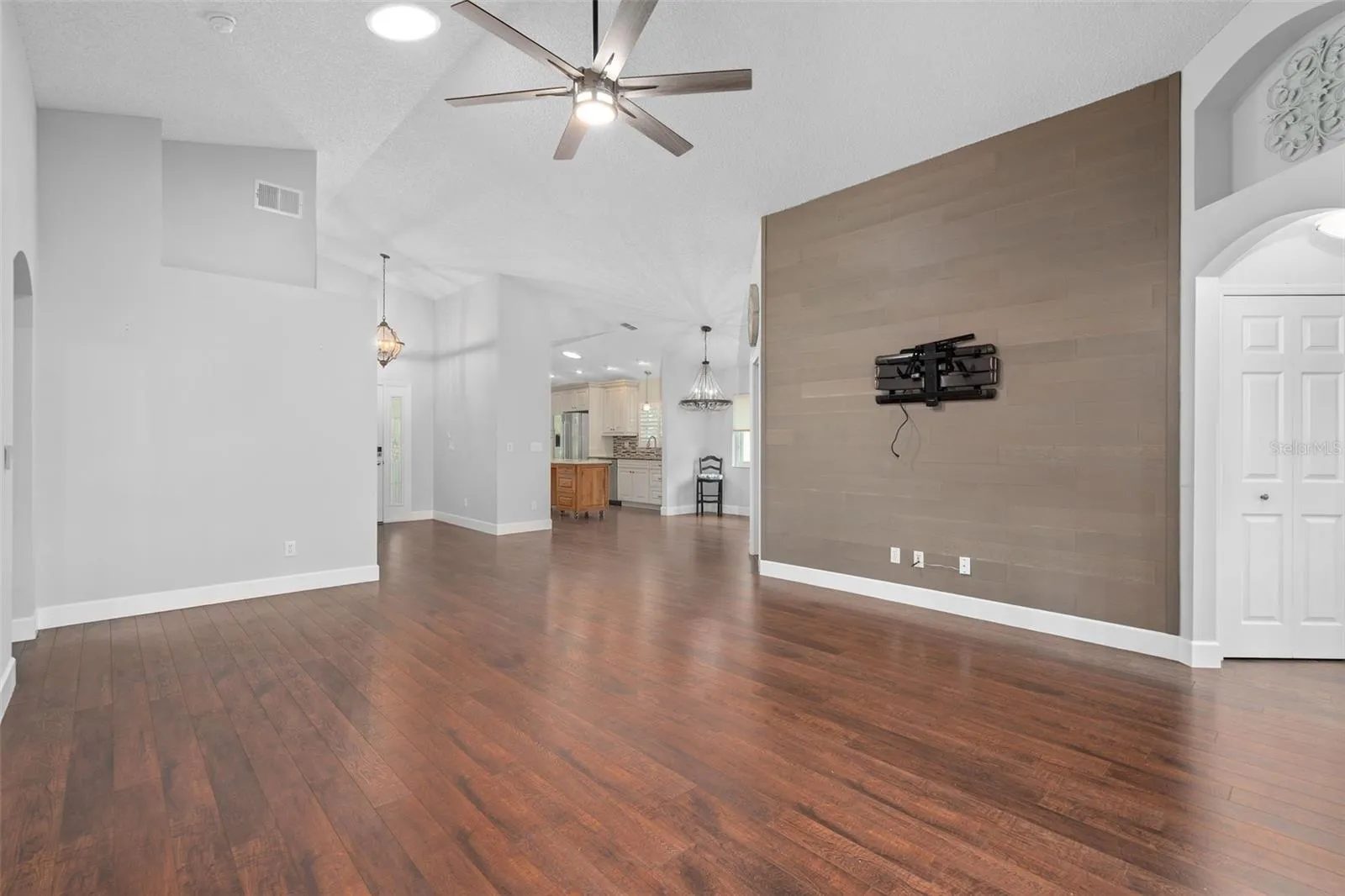 great room has a custom designed wood wall and upgraded fan. Home also has 4 solar tubes for extra light.
