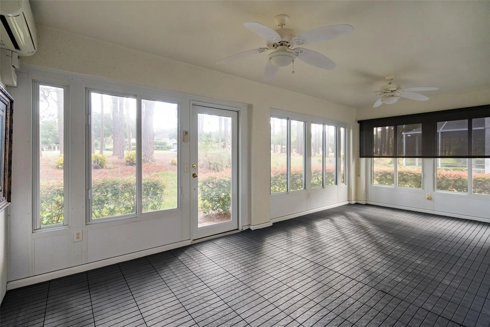 fully enclosed lanai with min split ac system and acrylic windows. Along with a custom laid floor. This rear lanai overlooks the 9th hole at the Kings Ridge Championship golf course.