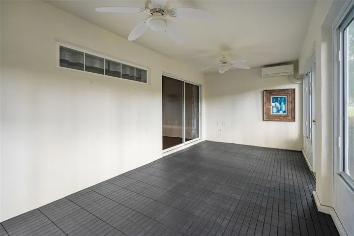 fully enclosed lanai with min split ac system and acrylic windows. Along with a custom laid floor. This rear lanai overlooks the 9th hole at the Kings Ridge Championship golf course.