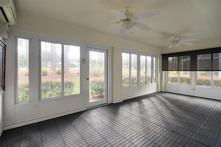 fully enclosed lanai with min split ac system and acrylic windows. Along with a custom laid floor. This rear lanai overlooks the 9th hole at the Kings Ridge Championship golf course.