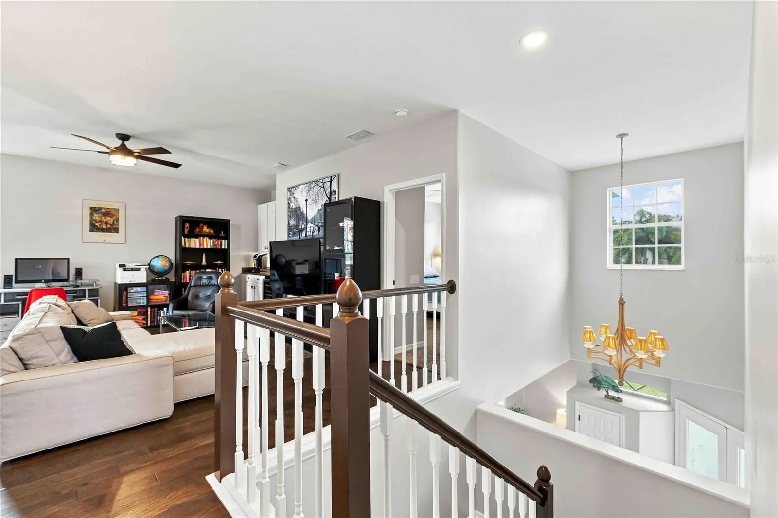 An open loft landing overlooks the foyer below, connecting the upstairs living space to the rest of the home