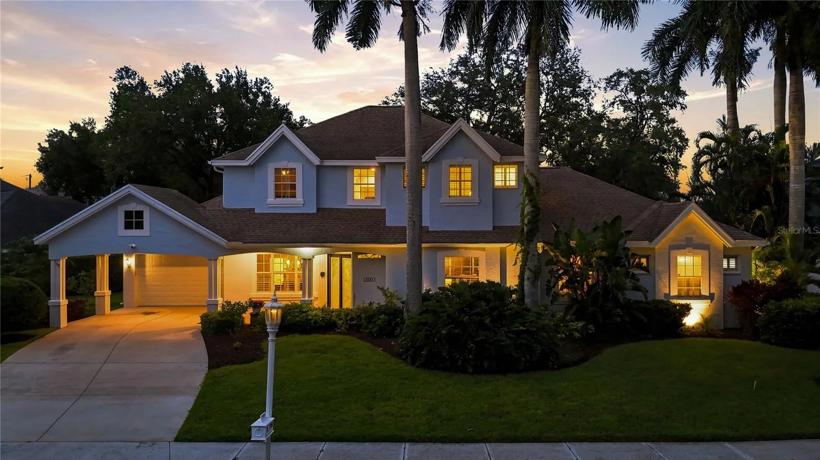 Welcome to a stunning two-story estate tucked under a canopy of oaks and palms on an oversized homesite