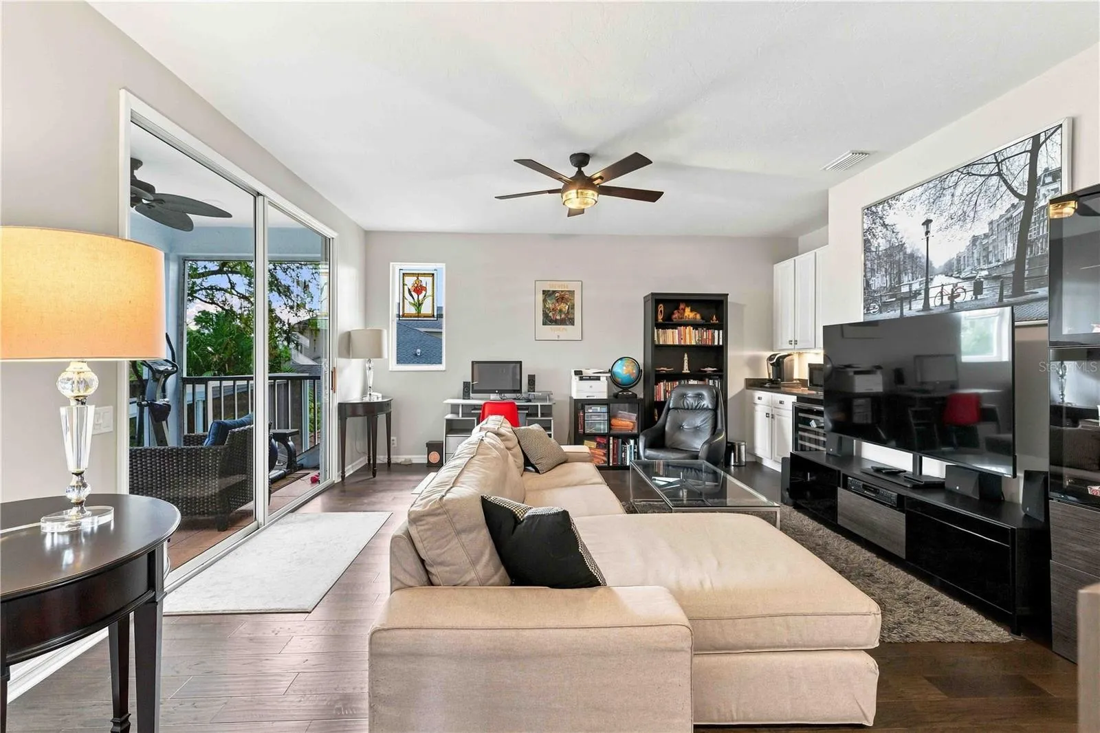 Sliders open to a private balcony, bringing in tree-top views and natural light.